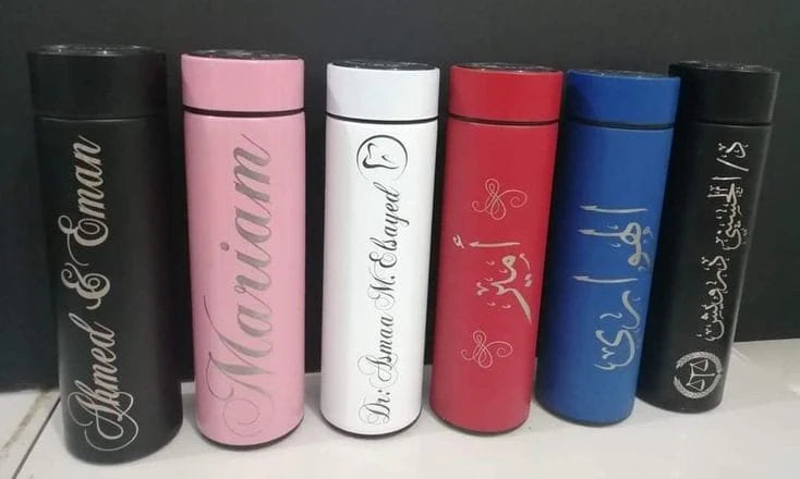 Set of six insulated bottles with personalized names on a dark background